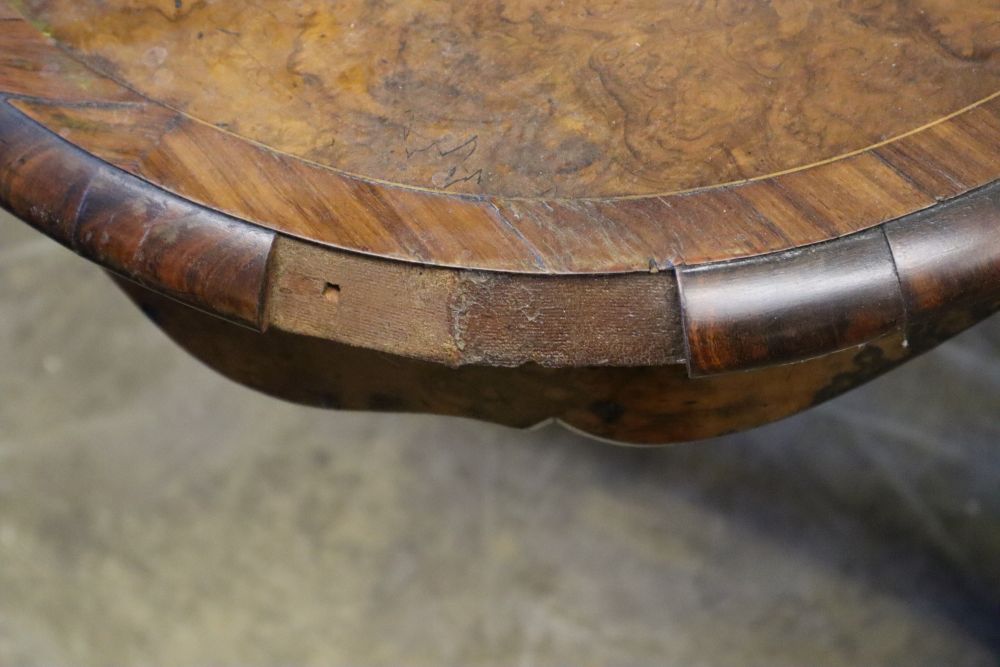 A Victorian figured walnut centre table of serpentine form, with ormolu mounted cabriole legs, width 130cm, depth 89cm, height 74cm